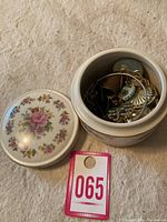 Porcelain trinket dish with lid and jewelry inside