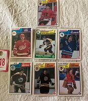 Seven NHL hockey player cards from 1983-84 O-Pee-Chee including Red Wings, Bruins, Jets, Rangers, and Black Hawks players.