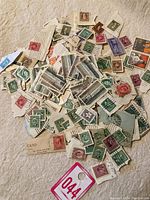 Lot of vintage Canadian postage stamps scattered with envelope corners and postmarks.