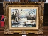 Full view of the framed original oil painting depicting a winter landscape with birch trees and snow.