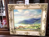 Frontal view of the oil painting showing landscape of Mountains of Mourne in a detailed ornate cream and gold frame.