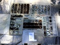 Photo showing organized storage cases with bolts, washers, nuts, and other fasteners sorted by size and type