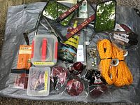 Overview of all car and trailer accessories laid out on a surface showing mirrors, wiring, reflectors, ropes, and other items.