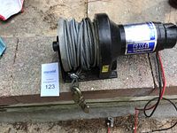 Side view of Superwinch EX1 mounted on base showing steel cable and hook.