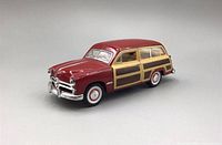 Maroon 1949 Ford Woody Wagon diecast model showing front and side with wood panel detailing and chrome on bumper and grille.