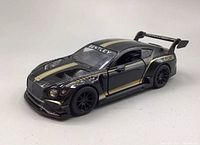 Front and side view of black and gold 2018 Bentley GT3 Kinsmart diecast model car showing detailed front grille, side vents, and aerodynamic features.