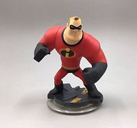 Front view of Mr. Incredible figurine in red costume with black gloves, boots, and mask, standing on themed base.