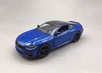Front-side angle of the blue Kinsmart BMW M8 Competition diecast model car showing exterior details with door closed.