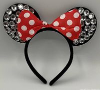 Photo of the Minnie Mouse kids headband showing black ears with rhinestones and red/white polka dot bow