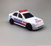 Front and side view of white Rescue Squad toy car showing red and blue stripes and emergency logos with black windows and wheels.