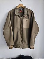 Front view of the men's Patagonia zip-up jacket with fleece collar and chest pocket with snap button.