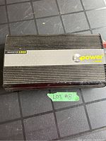 Top view of black XPower 1000W power inverter showing brand label and model number.