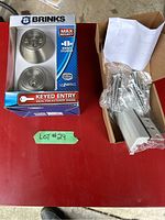 Photo showing Brinks double cylinder lock boxed and two additional security door locks in a box with hardware.