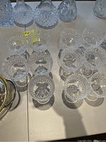 Top view of 11 crystal goblets arranged in two groups showing different textured patterns on the bowls.