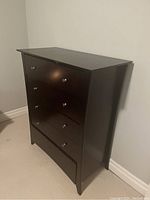 Front angled view of the espresso stain dresser showing all five drawers with knobs, bottom drawer handles detached in drawer