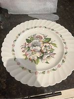 Front view of cake plate showing floral pattern and scalloped edge