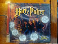 Front cover of Harry Potter Reel Coinz collectible package featuring characters and 5 visible coins