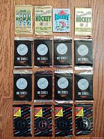 Top view of 16 unopened vintage NHL hockey card packets laid out on a wooden surface showing various years and series, including 1991, 1992, 1993 OPC Hockey and NHL Series I packs.