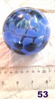 Blue glass witches ball showing varied blue shades and surface pattern