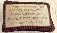 Front side of pillow showing embroidered humorous message about brother.