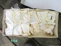 Boxed set with two small clear glasses visible, wrapped in tissue paper.