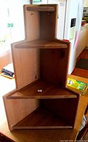 Front view of the solid pine IKEA corner shelf showing overall shape and design.