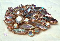 Full view of the suspected Sherman brooch showing the arrangement of varied Aurora Borealis rhinestones in a gold-tone metal setting.