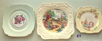 Three vintage china plates arranged side by side showing different floral designs and shapes.