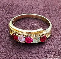 Overhead view of ring showing five multicolored stones across top of band