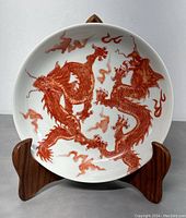 Front view of bowl showing red double dragon design on white glaze