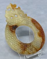 Front view of carved Chinese jade bi disc showing textured pattern and natural color variations.