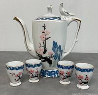 Full set: teapot and four cups arranged together