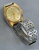 Overall front angled view of vintage Longines women's automatic watch with gold-tone case and stainless steel bracelet.
