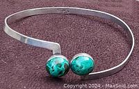Front close-up of vintage sterling silver bangle showing malachite stones and sterling silver marking.
