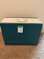 Blue and white hard carrying case housing Brother sewing machine, shown closed from front