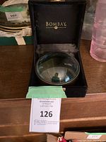 Desk magnifier in black velvet box branded 'Bombay'