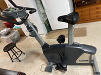 Full side view of gray Nautilus U616 exercise bike showing the frame, seat, and pedals.