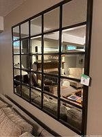 Front view of entire mirror mounted on wall showing grid pattern