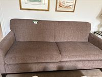 Front view of brown fabric sofa showing overall condition