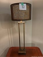 Full view of the brass table lamp with rectangular base and two-tiered drum shade showing the overall shape and style.