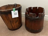 Pair of rustic wooden pails side by side showing their size difference and wear