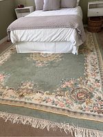 Overall view of rug placed under bed showing full pattern and scale