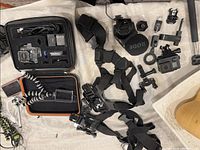 Overhead view of two GoPro cameras, cases, mounts, straps and mic