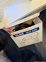 Top view of Uline Heat Gun in its original box, showing the power cord and partial interior.