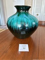 Front view of large Blue Mountain Pottery vase showing full shape and drip glaze design in turquoise and green over black.