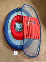 Full view of the infant pool floatie showing blue mesh seating area, red inflatable ring, and attached red sunshade canopy with mesh panel and marine designs.