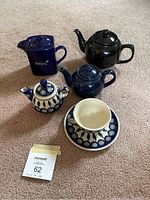 Front angle showing four teapots and matching cup and saucer from the front
