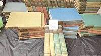 Complete set of Britannica Great Books stacked and arranged showing variety of spine colors and titles