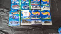 Photo showing all 11 Hot Wheels Treasure Hunts limited edition cars in original blister packaging arranged on surface.