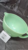 Full view of the Jadeite FireKing 2.5 quart mixing bowl showing the spout and handle